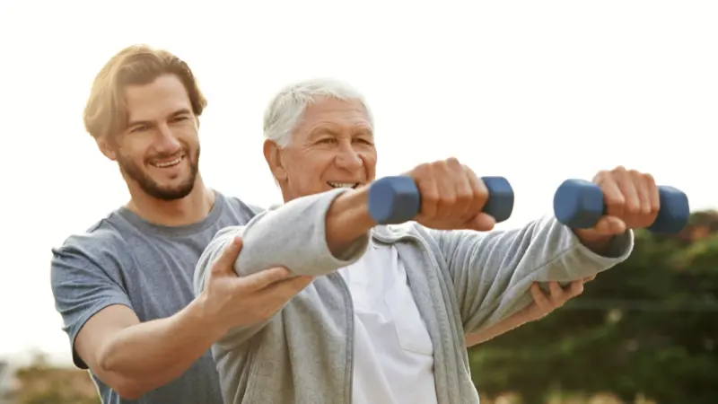 Older adult performing resistance training with guidance to support muscle strength and healthy aging