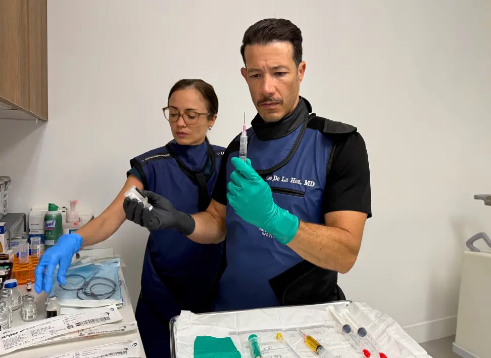 Dr. Carlos De La Hoz preparing stem cell injection in clinical setting at NeoMedicine Institute in Miami