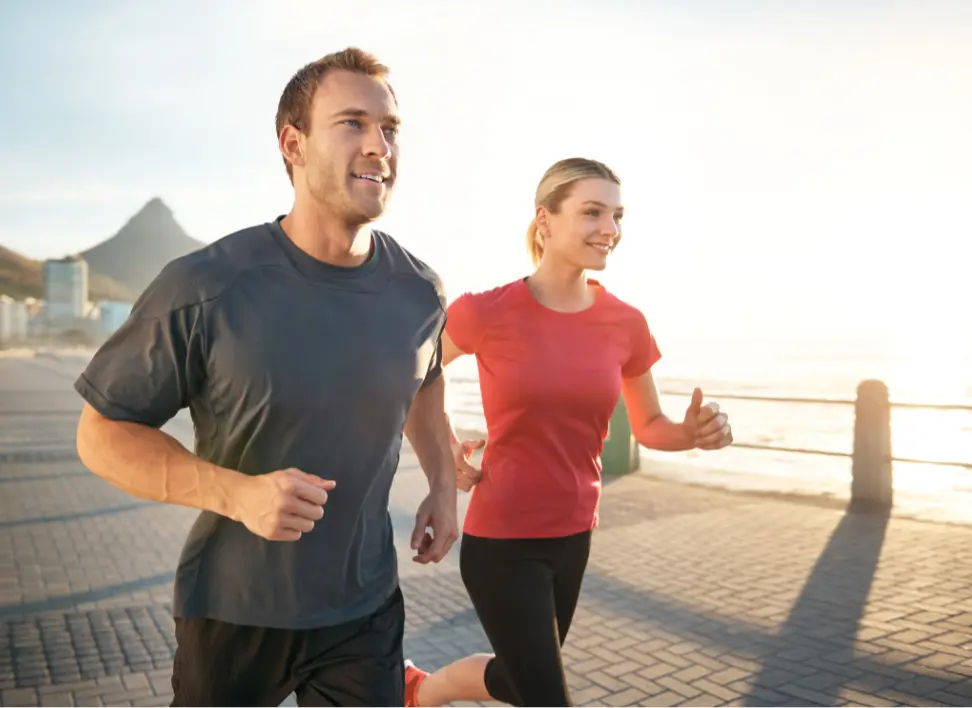 Active couple running outdoors representing long-term health, vitality, and reduced chronic inflammation