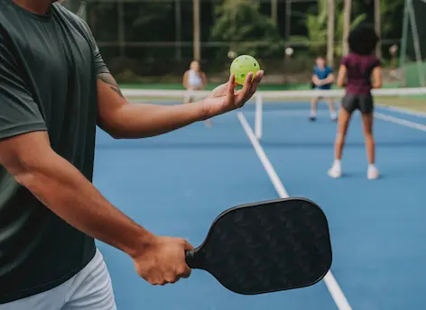 Man playing pickleball representing active lifestyle and mobility supported by stem cell therapy