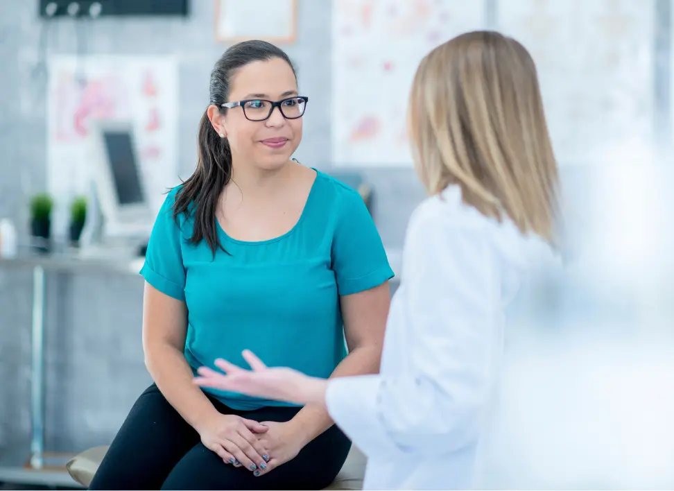 Woman speaking with a doctor about hormone imbalance symptoms and treatment options
