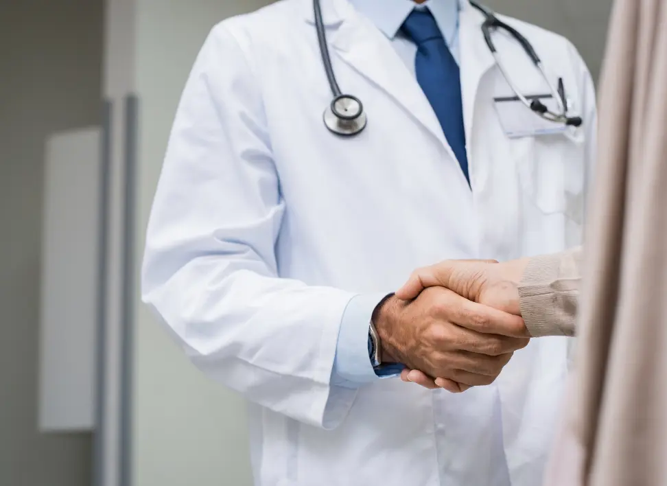 Physician shaking hands with patient representing personalized care and treatment for chronic inflammation and long-term health