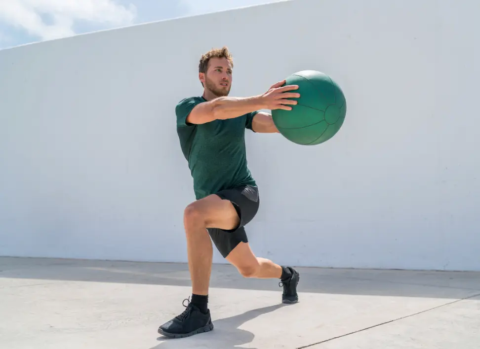 Man performing strength exercise to improve muscle mass and performance related to testosterone levels