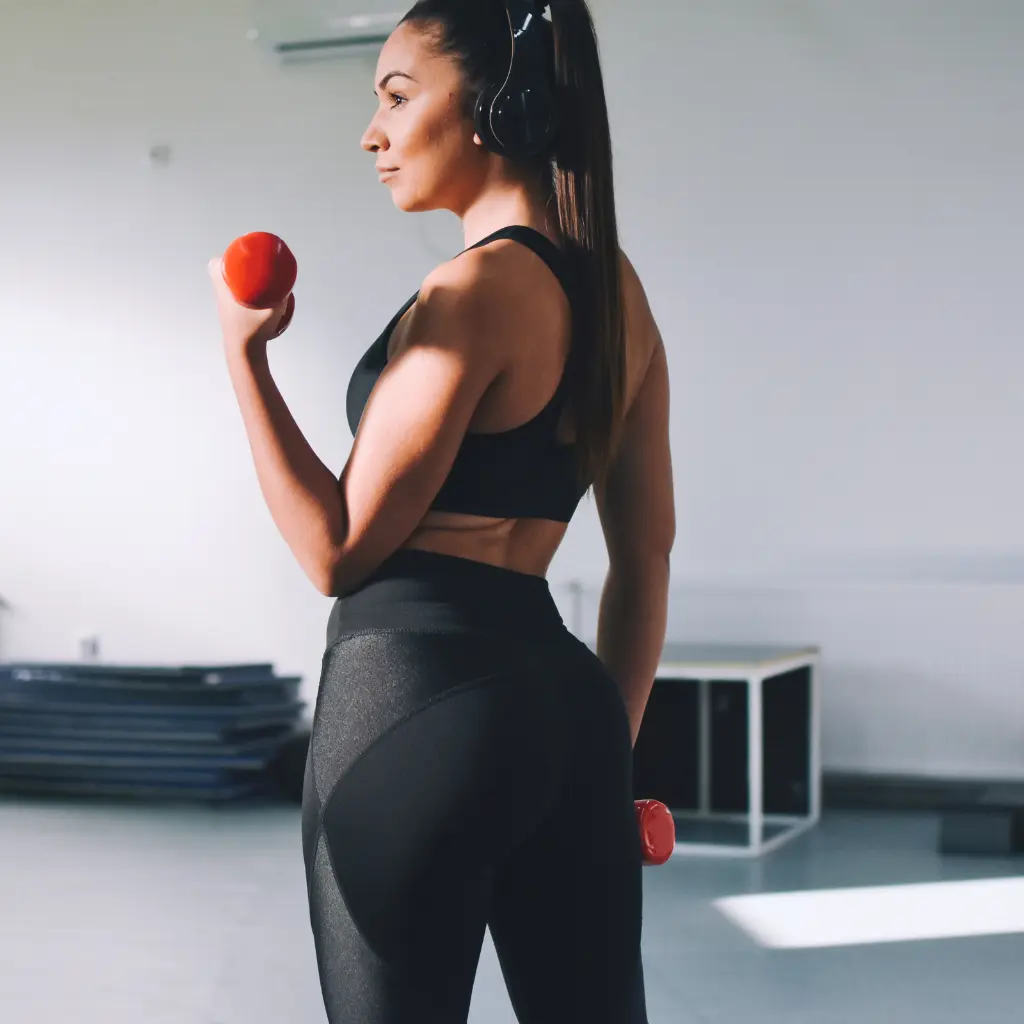 Woman training with weights representing strength and longevity medicine at NeoMedicine Institute Miami FL
