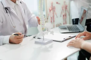 Dr. reviewing chart with patient and zoning in together on their chronic back pain