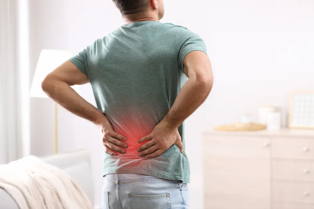 young patient with lower back pain from working 8-10 hours a day on computer