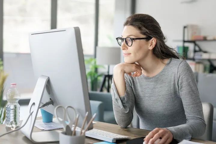 women sitting at computer for many hours causing chronic back pain