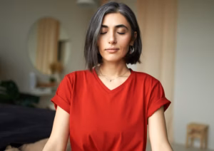 Woman with closed eyes sitting calmly at home